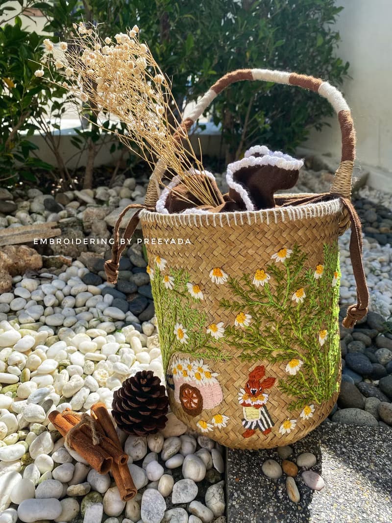 Thai woven rattan bag with hand-embroidered daisy and rabbit pattern