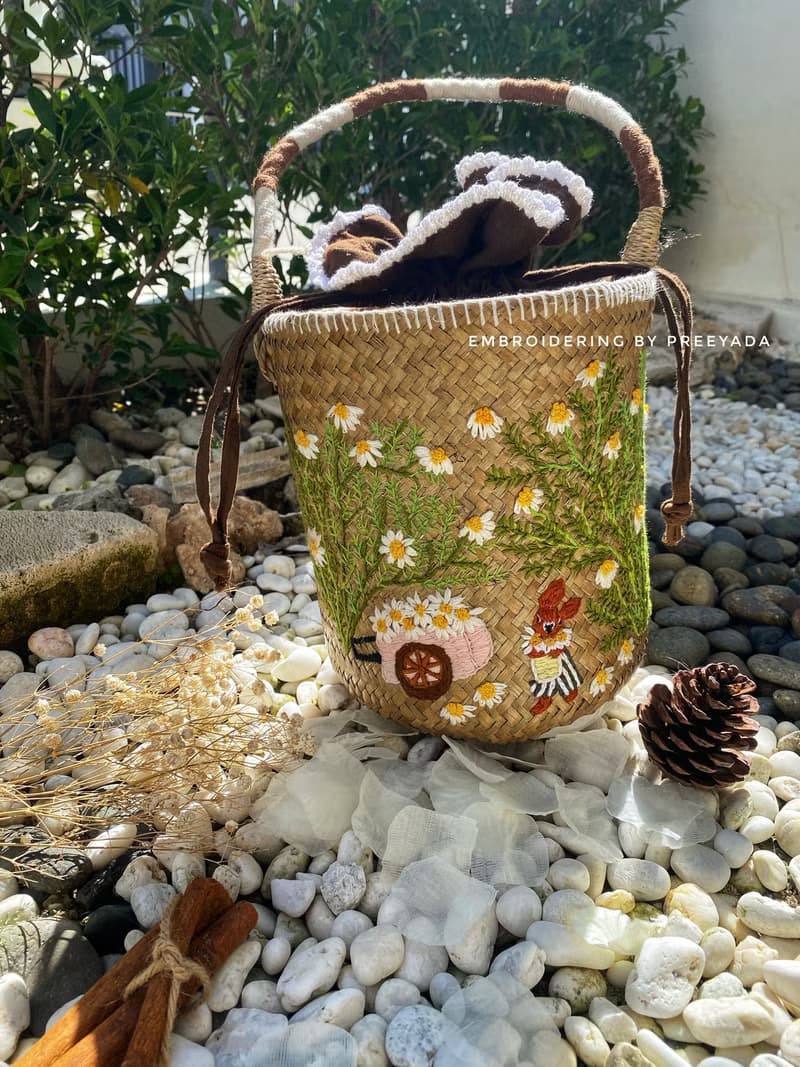 Thai woven rattan bag with hand-embroidered daisy and rabbit pattern
