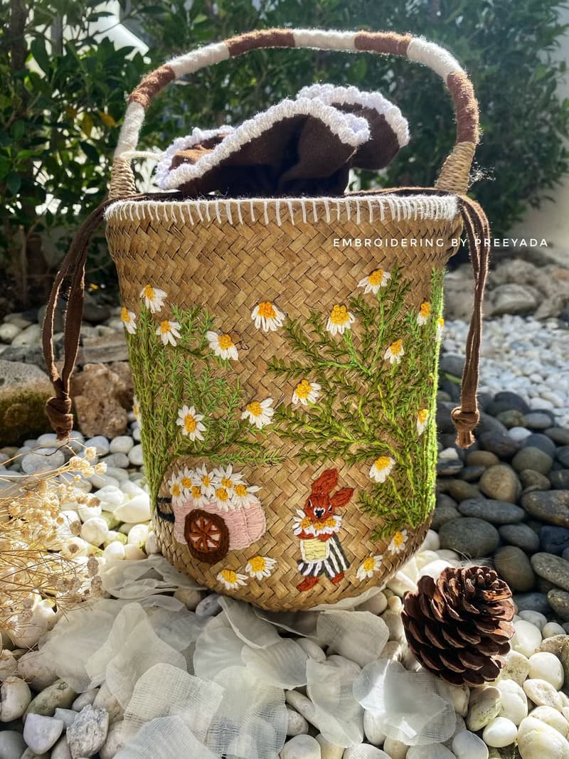 Thai woven rattan bag with hand-embroidered daisy and rabbit pattern