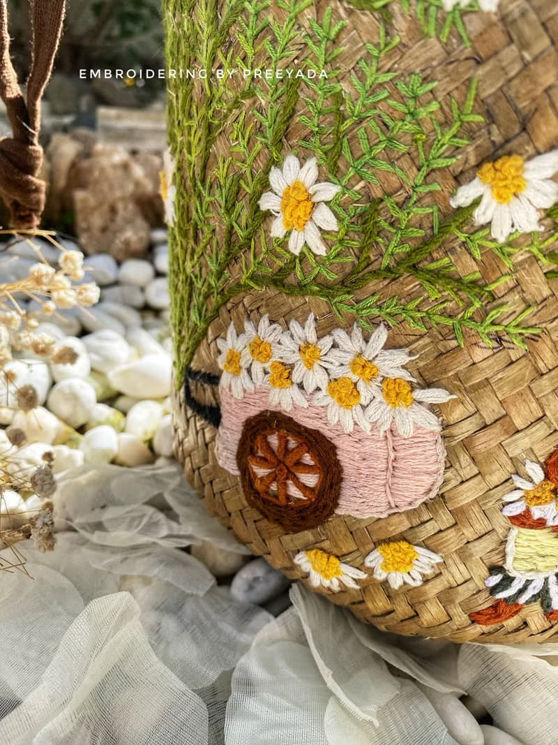 Thai woven rattan bag with hand-embroidered daisy and rabbit pattern