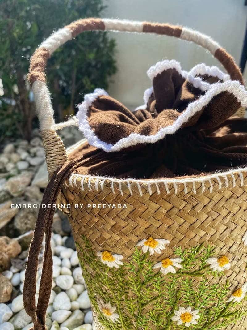 Thai woven rattan bag with hand-embroidered daisy and rabbit pattern