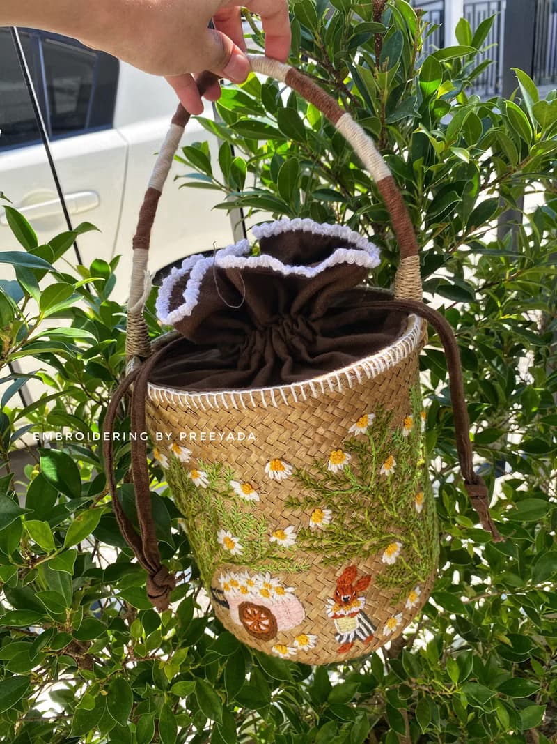 Thai woven rattan bag with hand-embroidered daisy and rabbit pattern