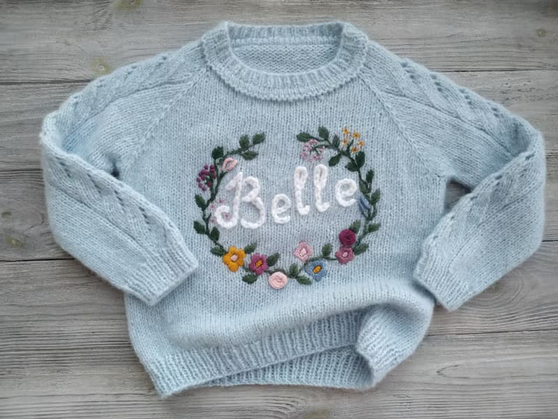 Handmade alpaca sweater with baby's name and embroidered flowers. First gift.