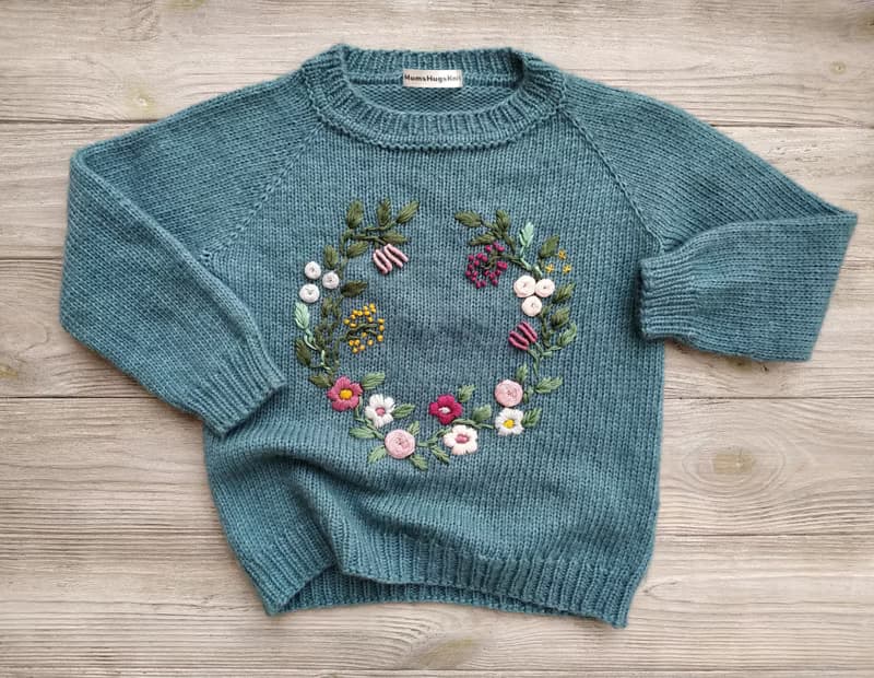 Handmade alpaca sweater with baby's name and embroidered flowers. First gift.