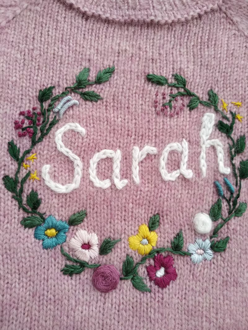 Handmade alpaca sweater with baby's name and embroidered flowers. First gift.