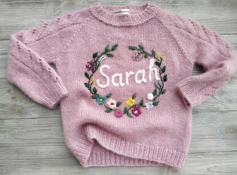 Handmade alpaca sweater with baby's name and embroidered flowers. First gift.