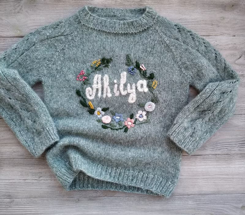 Handmade alpaca sweater with baby's name and embroidered flowers. First gift.