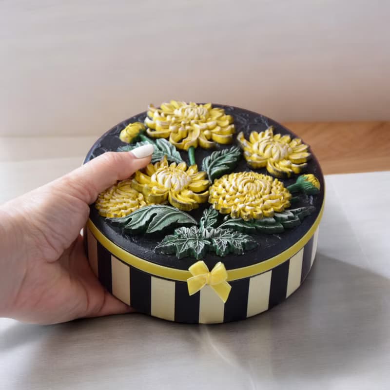 Round jewelry storage box with voluminous yellow chrysanthemum flowers