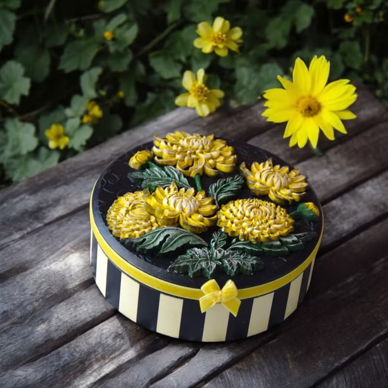 Round jewelry storage box with voluminous yellow chrysanthemum flowers