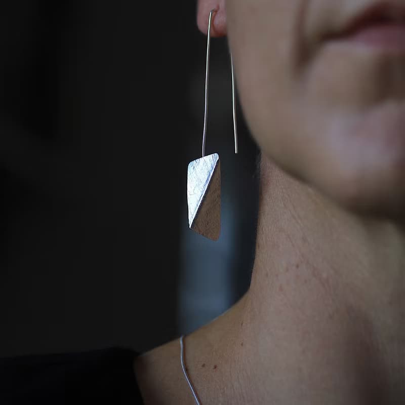 Handmade earrings with bended textured silver pieces on a long stem (E0184)