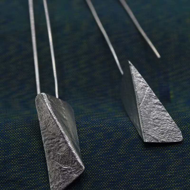 Handmade earrings with bended textured silver pieces on a long stem (E0184)