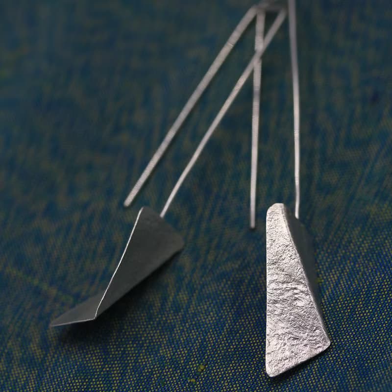 Handmade earrings with bended textured silver pieces on a long stem (E0184)