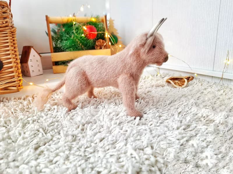 Realistic animal toy Bull Scotland wool yarn sculpture. Interior decor eco-style