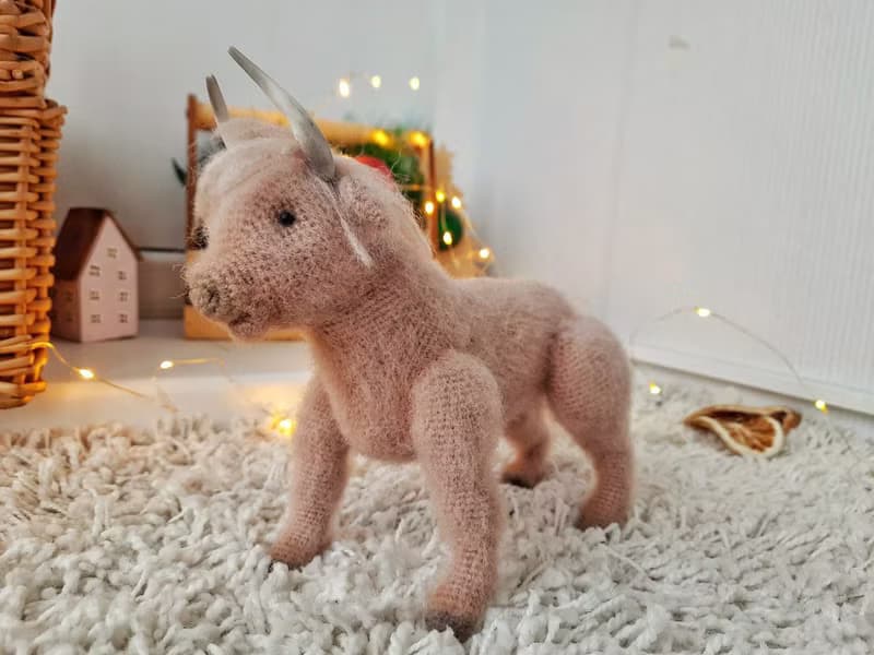 Realistic animal toy Bull Scotland wool yarn sculpture. Interior decor eco-style
