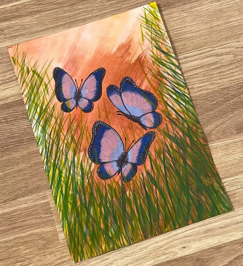 Cheerful dancing butterflies in green grass. Watercolor.