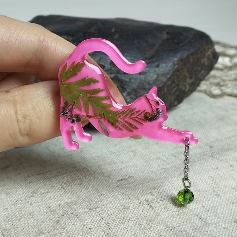 粉紅貓別針。帶有綠葉的粉紅色貓胸針。手工製作的樹脂胸針。