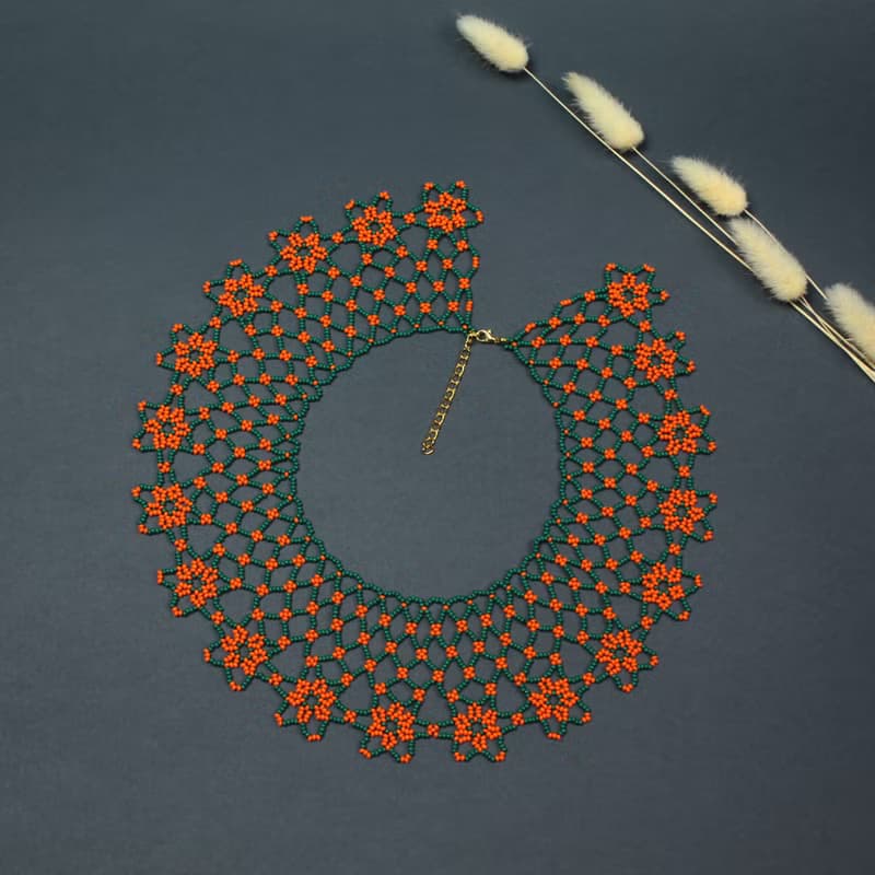 Green necklace with orange flower