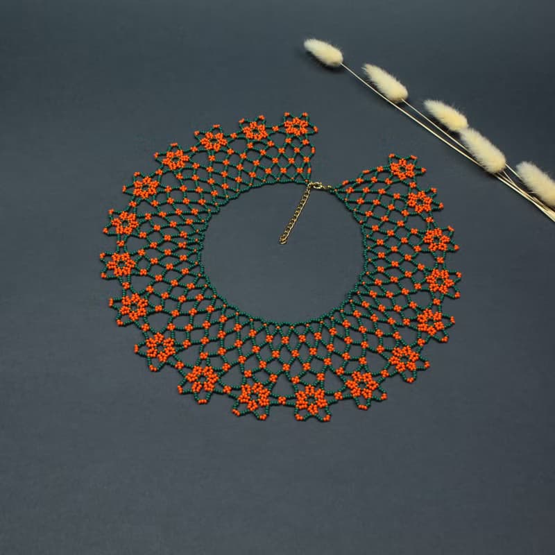 Green necklace with orange flower