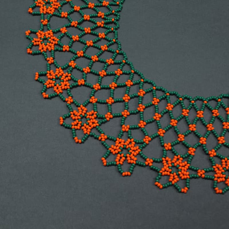 Green necklace with orange flower