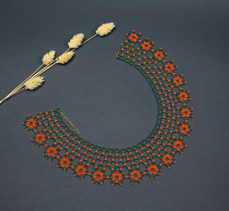 Green necklace with orange flower