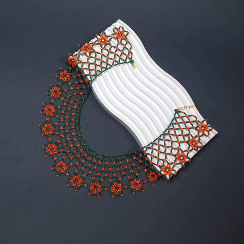 Green necklace with orange flower