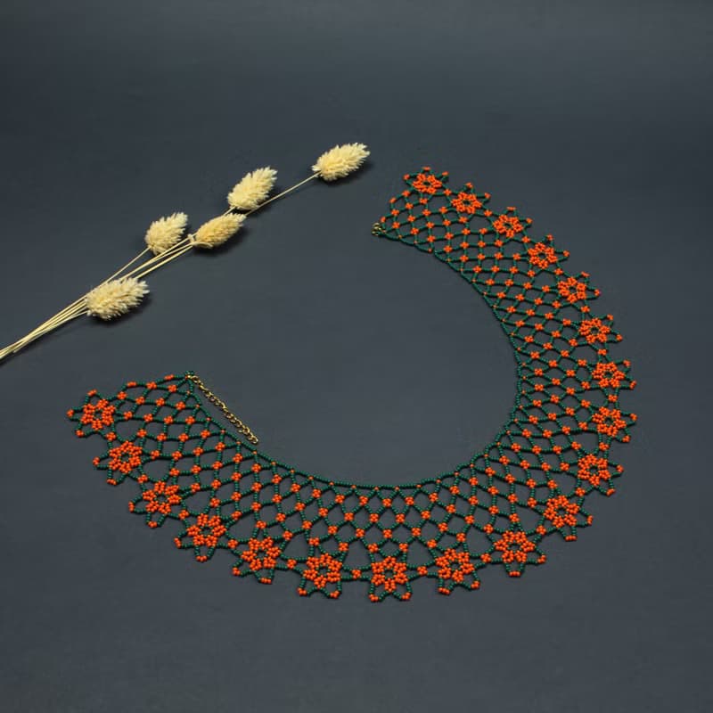 Green necklace with orange flower