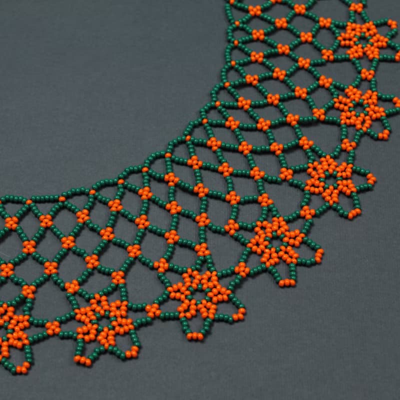 Green necklace with orange flower