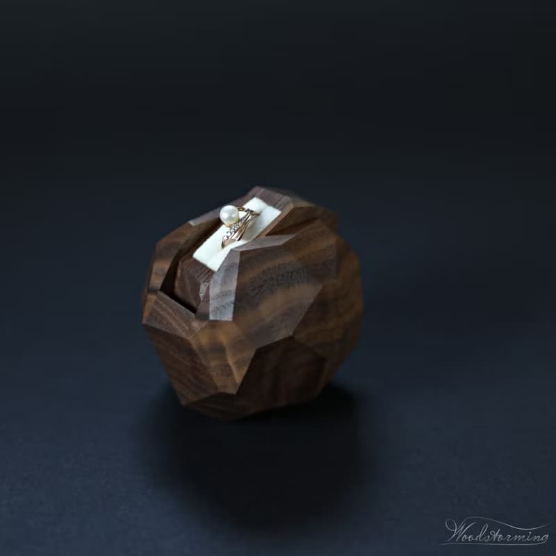 Wooden faceted sculptural ring display with white pillow by Woodstorming
