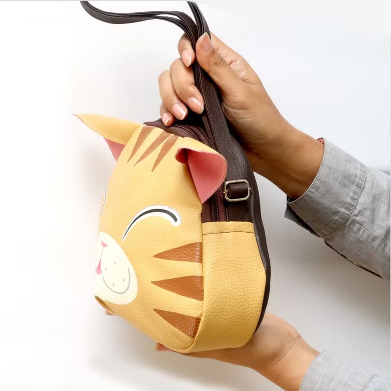 Orange cat crossbody bag is compact fro carrying mobile phones.