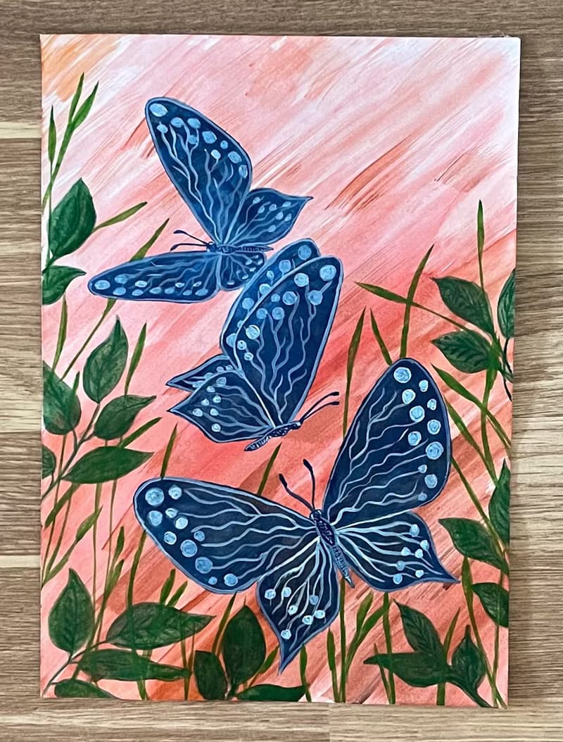 White-blue butterflies against the backdrop of fiery sunset.