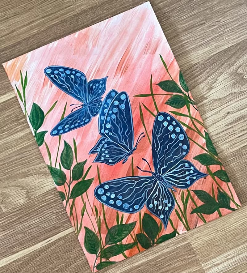 White-blue butterflies against the backdrop of fiery sunset.