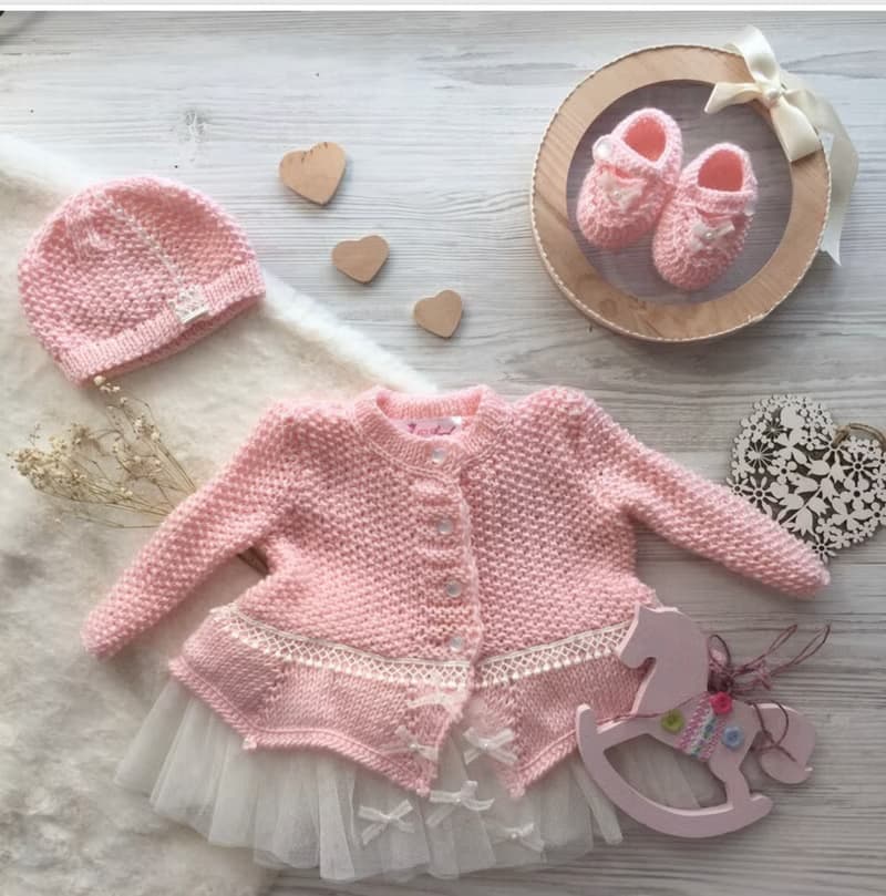 Hand knit pink outfit for baby girl. Dress with pearls and lace, hat, booties.