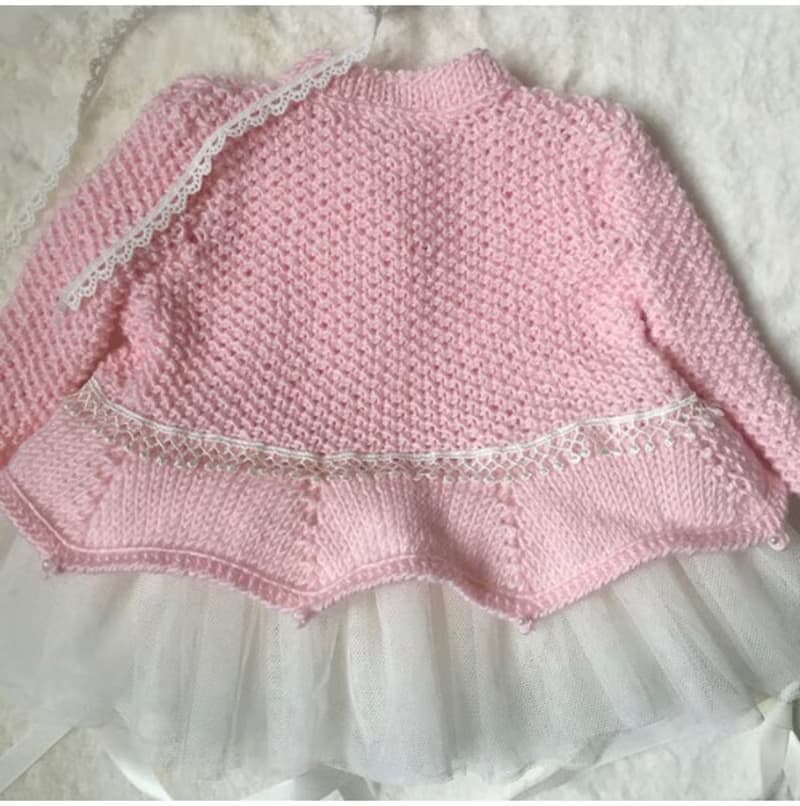 Hand knit pink outfit for baby girl. Dress with pearls and lace, hat, booties.