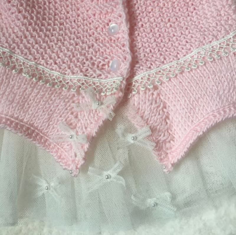 Hand knit pink outfit for baby girl. Dress with pearls and lace, hat, booties.