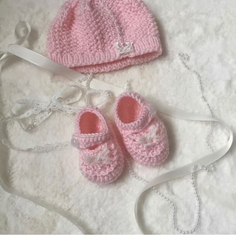 Hand knit pink outfit for baby girl. Dress with pearls and lace, hat, booties.