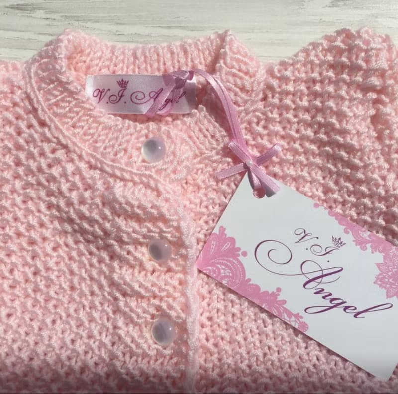 Hand knit pink outfit for baby girl. Dress with pearls and lace, hat, booties.