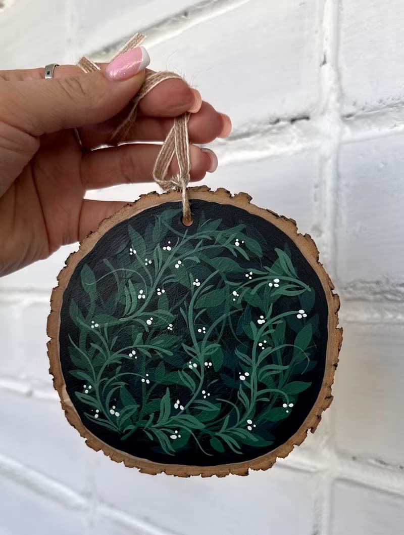 Delicate Floral Ornament on Wooden Slice