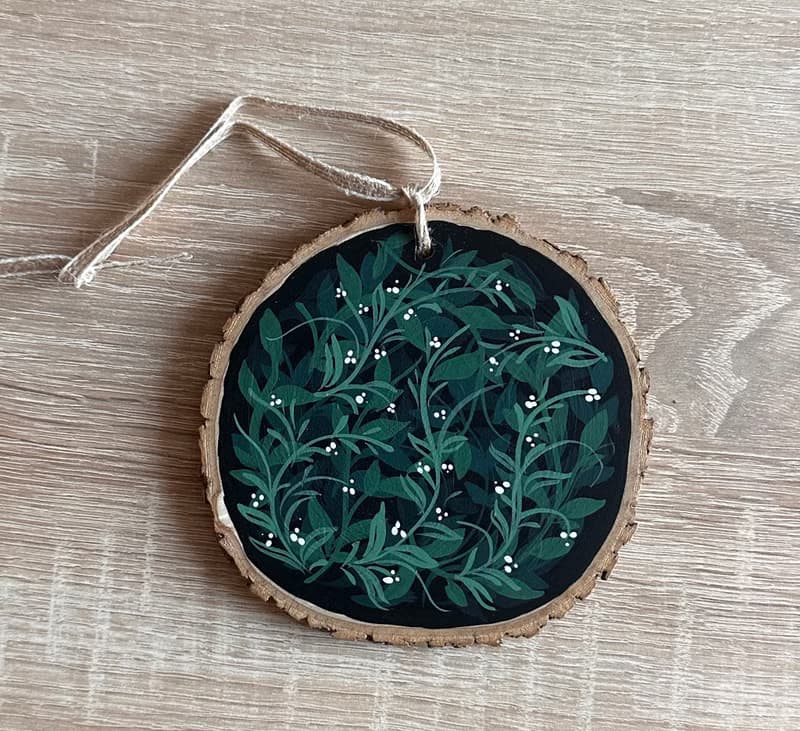 Delicate Floral Ornament on Wooden Slice