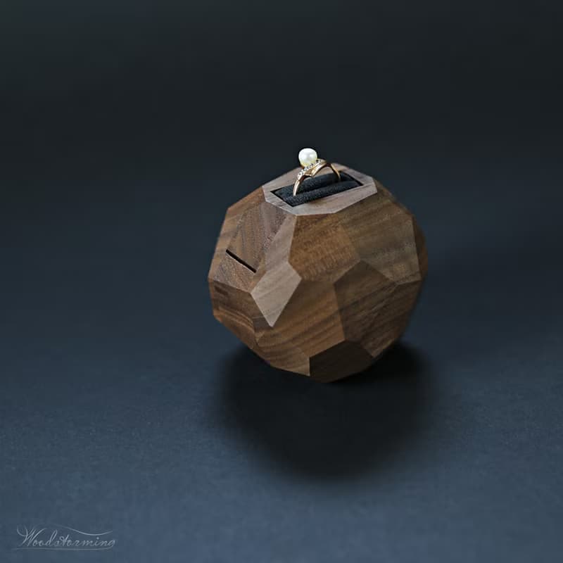 Wooden faceted sculptural ring display with black pillow, proposal ring box