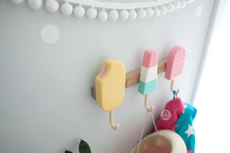 Clothes and towel hanger for nursery with wooden ice cream hooks