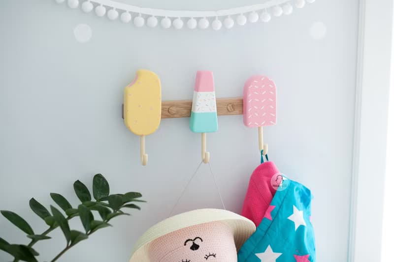 Clothes and towel hanger for nursery with wooden ice cream hooks