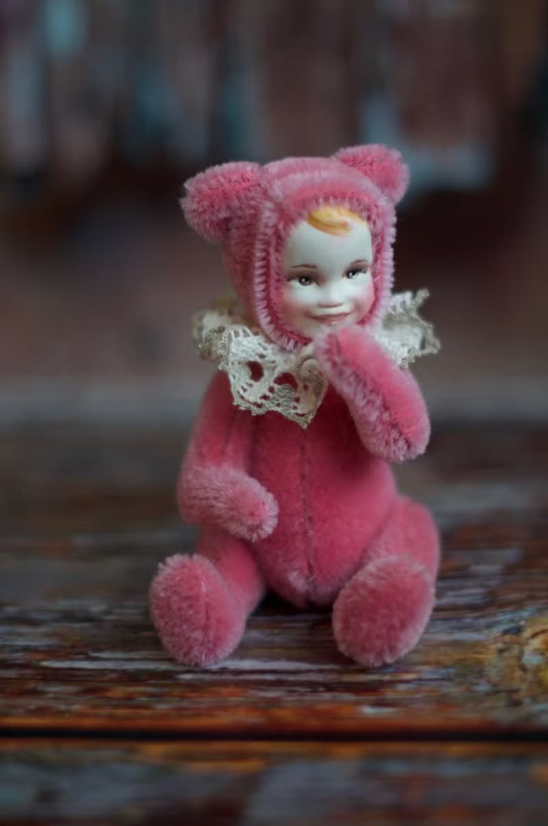 Raspberry teddy doll created with pink mohair with hand painted face