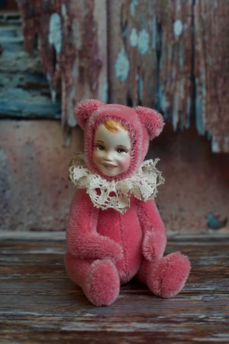 Raspberry teddy doll created with pink mohair with hand painted face