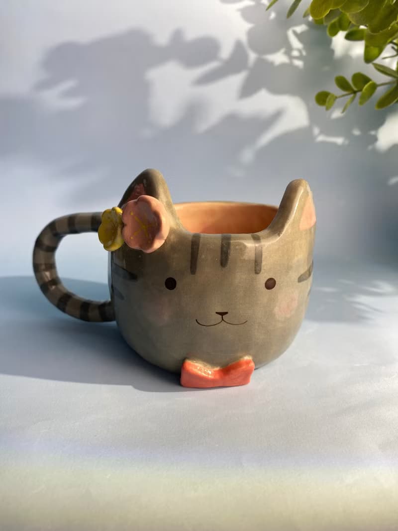Handmade ceramic cup. Handmade ceramic mug with cute cat and flower lover.
