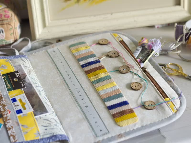Handmade needles-and-tools organizer with hand cross stitched bouquet