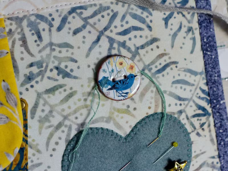 Handmade needles-and-tools organizer with hand cross stitched bouquet