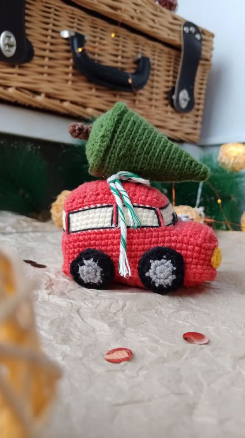 Red car with Christmas tree for gift. Holiday toy home decor. New year red car