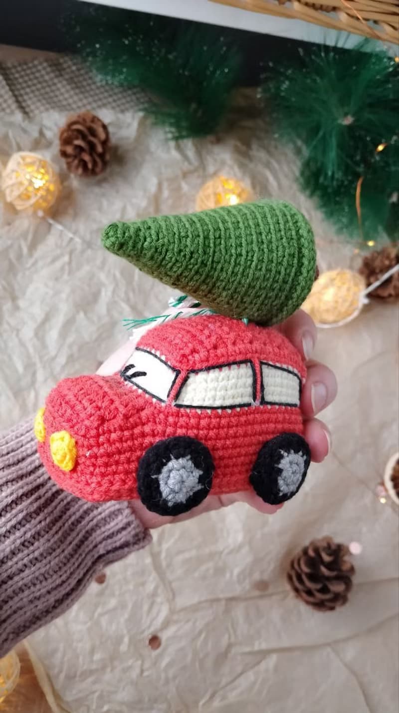 Red car with Christmas tree for gift. Holiday toy home decor. New year red car