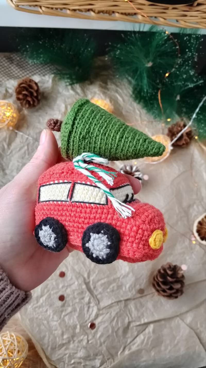 Red car with Christmas tree for gift. Holiday toy home decor. New year red car