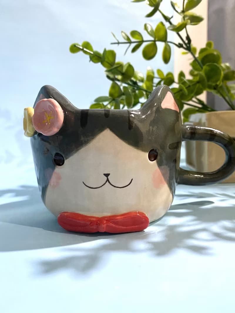 Handmade ceramic cup. Handmade ceramic mug with cute cat and flower lover for gifts.